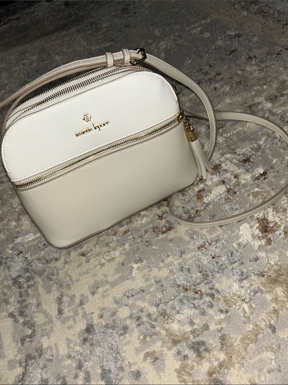 New White and Cream Pebbled Leather Crossbody with Tassel, adjustable strap.